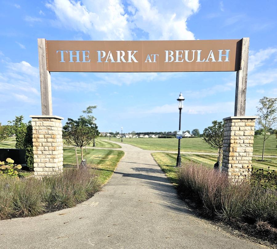 The Park at Beulah entrance arch over a walking path opening onto the central green