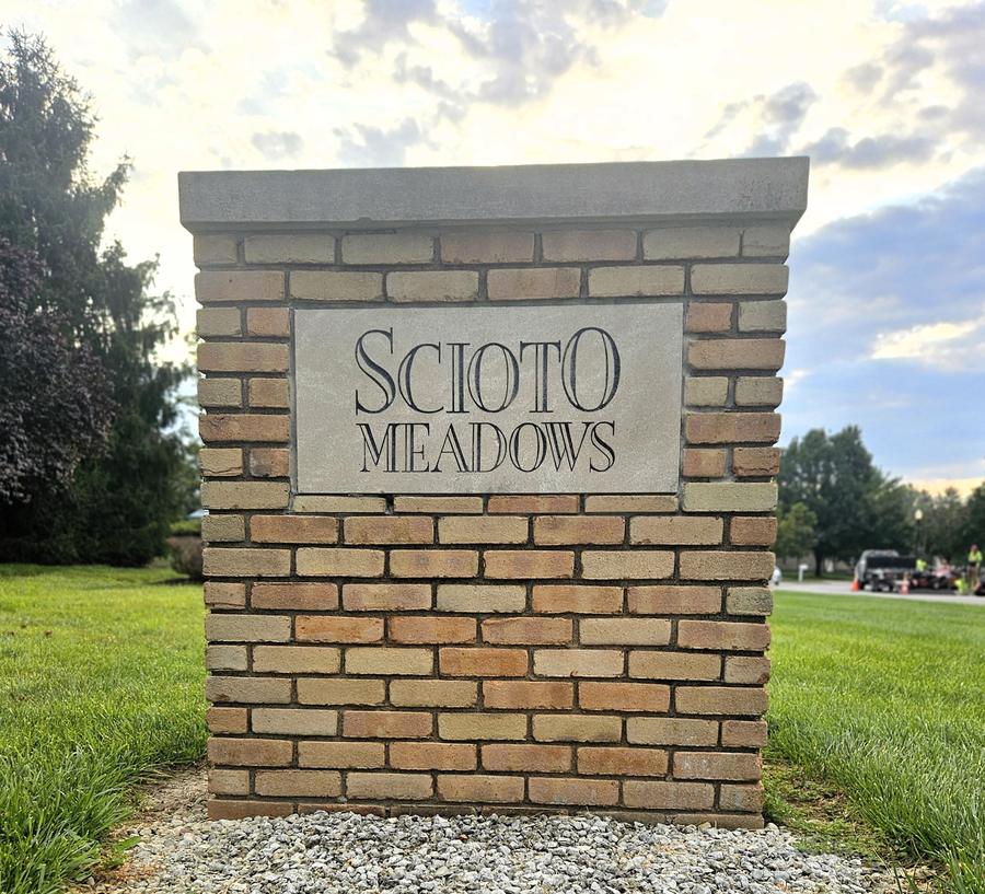 Scioto Meadows entrance sign, a brick monument with a carved limestone panel